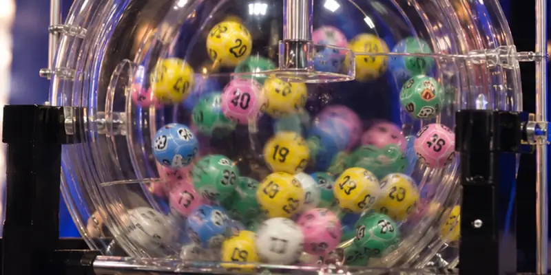 Lottery drawing machines select numbered balls during official prize draws.